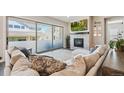 Comfortable living room with a cozy fireplace and a large sliding glass door that provides lots of natural light at 14160 Ivanhoe St, Thornton, CO 80602