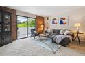Cozy living room with a gray sectional, modern decor, and sliding glass doors to a balcony at 2880 S Locust St # 305N, Denver, CO 80222