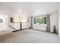 Spacious living room featuring neutral carpet, large windows and modern railing at 2843 S Otis St, Denver, CO 80227