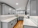 Modern kitchen featuring light gray cabinets, stainless appliances, and white countertops at 10025 W 8Th Ave, Lakewood, CO 80215