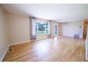 Bright living room with hardwood floors, large windows, and neutral paint, creating a welcoming atmosphere at 885 Balsam St, Lakewood, CO 80214