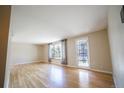 Bright living room with hardwood floors, large windows, and neutral paint, creating a welcoming atmosphere at 885 Balsam St, Lakewood, CO 80214