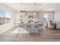 Open-concept kitchen with a large island, pendant lighting, and stylish seating, perfect for entertaining at 22083 E 38Th Pl, Aurora, CO 80019