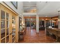 Spacious foyer boasts soaring ceilings, gleaming hardwood floors, and a view into the living area at 14582 Homestead Pl, Broomfield, CO 80023