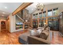 Comfortable living room offers lots of natural light, fireplace, hardwood floors, and open floor plan at 14582 Homestead Pl, Broomfield, CO 80023