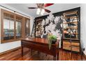 Cozy office features hardwood floors, decorative wallpaper, and abundant shelving at 14582 Homestead Pl, Broomfield, CO 80023