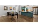 Modern dining area with stylish table, connected to a kitchen with sleek countertops at 2322 Arapahoe St, Denver, CO 80205