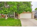 Charming two-story home with stone accents and a two-car garage enhancing its curb appeal at 5136 S Ceylon St, Centennial, CO 80015