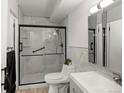Modern bathroom with sleek glass enclosed shower, white marbled tile and updated vanity at 9150 E Center Ave # 7C, Denver, CO 80247