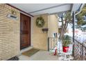 Inviting front entrance with a wooden door and festive wreath at 9581 Green Ct, Westminster, CO 80031