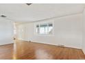 Bright living room with hardwood floors and large window at 8566 Flintwood Rd, Parker, CO 80138