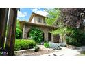 Charming two-story home with a stone facade, arched entryway, and professionally landscaped front yard at 10328 Bluffmont Dr, Lone Tree, CO 80124