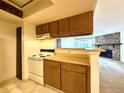 Kitchen featuring wood cabinets, white appliances, and a view into the living room at 1870 S Pitkin Cir # B, Aurora, CO 80017