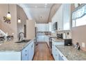 Kitchen featuring granite countertops, stainless appliances, and white cabinetry at 479 W Jamison Cir, Littleton, CO 80120