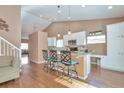 Bright, eat-in kitchen featuring granite counters and white cabinets at 479 W Jamison Cir, Littleton, CO 80120