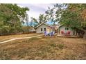 Charming home featuring a spacious backyard with a stone walkway, and an inviting seating area at 3074 S Elati St, Englewood, CO 80110