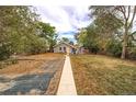 Charming home featuring a spacious backyard with a stone walkway, and an inviting seating area at 3074 S Elati St, Englewood, CO 80110