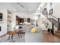 A comfortable living room featuring a large sectional sofa, hardwood floors, and an open concept design at 9154 E 37Th Ave, Denver, CO 80238