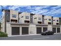 Modern townhomes with gray-toned siding and brick exteriors feature car garages for convenient parking at 838 N Cherry St # 1, Denver, CO 80220