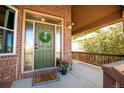 Inviting front porch with green door and wood railings at 5952 E Conservation Dr, Frederick, CO 80504