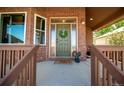 Inviting front porch with green door and wood railings at 5952 E Conservation Dr, Frederick, CO 80504