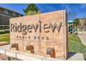 Community sign 'Ridgeview Eagle Bend' with stone base and manicured landscaping at 7511 S Sicily Way, Aurora, CO 80016