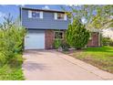 Charming two-story home with brick and siding, attached garage, and well-maintained landscaping at 807 Mobile St, Aurora, CO 80011