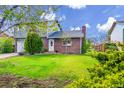 Charming home with a well-manicured lawn and mature trees, creating great curb appeal at 807 Mobile St, Aurora, CO 80011
