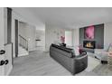 Open concept living room with fireplace, and staircase, perfect for modern living at 807 Mobile St, Aurora, CO 80011