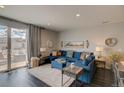 Inviting living room with a blue sectional, neutral decor, and sliding glass doors to the patio at 1868 Makley Loop, Castle Rock, CO 80104