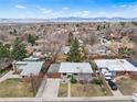 A beautiful aerial view of a single-Gathering home nestled in a suburban neighborhood with mountain views at 6445 Balsam St, Arvada, CO 80004