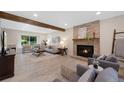 Inviting living room showcasing a cozy fireplace, wood beam and neutral decor for a comfortable atmosphere at 8433 S Painted Sky St, Highlands Ranch, CO 80126