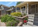 Close up on the front of the house, a quaint entrance featuring manicured garden and stairs at 2146 S Ellis Ct, Lakewood, CO 80228
