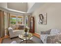 Cozy living room featuring large windows, vaulted ceilings, comfortable seating, and a decorative area rug at 2146 S Ellis Ct, Lakewood, CO 80228