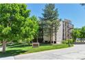 Exterior view of Morningside Condominiums, showcasing lush landscaping and building facade at 3470 S Poplar St # 404, Denver, CO 80224