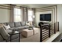 Cozy living room featuring a large sectional sofa, decorative pillows, and modern decor at 9973 Worchester St, Commerce City, CO 80022