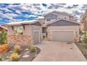 Charming two-story home featuring stone accents, a two-car garage, and a beautifully landscaped front yard at 17630 W 94Th Dr, Arvada, CO 80007