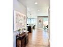 Hallway view with art and table setting, showing the house's flowing open floor plan at 17630 W 94Th Dr, Arvada, CO 80007
