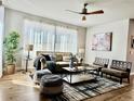 Bright living room with a ceiling fan, comfortable seating, and elegant decor at 17630 W 94Th Dr, Arvada, CO 80007