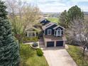 Beautiful, elevated view of the home showing the landscaped yard and neighborhood at 18 Brixham Ct, Castle Pines, CO 80108