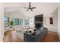 Bright living room with vaulted ceilings, fireplace, modern furniture, and lots of natural light at 18 Brixham Ct, Castle Pines, CO 80108