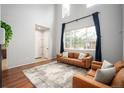 Living room with hardwood floors, fireplace and view of entryway at 12826 W Brittany Dr, Littleton, CO 80127