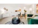 Open living space with neutral walls, stylish decor, and seamless flow into dining and kitchen areas at 3452 S Eagle St # 101, Aurora, CO 80014