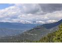 Distant snow-capped mountains and valley views at 34127 Cactus Dr, Evergreen, CO 80439