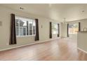 A bright living room with light-colored floors and natural light from several windows at 1356 Carlyle Park Cir, Highlands Ranch, CO 80129