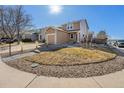 Charming home featuring a well-manicured lawn, stone walkway, and a welcoming front entrance with an attached garage at 715 Mockingbird St, Brighton, CO 80601