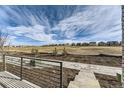 View of the backyard and neighborhood with an attractive fence and open space at 1288 S Algonquian St, Aurora, CO 80018