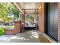 Relaxing front porch with swing and brick accents at 2063 Cherry St, Denver, CO 80207