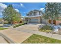 Beautiful two-story home boasts a spacious driveway and a three-car garage at 20948 E Hamilton Ave, Aurora, CO 80013