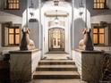 Elegant entryway with ornate details, stone steps, and unique statues at 727 N Washington St, Denver, CO 80203